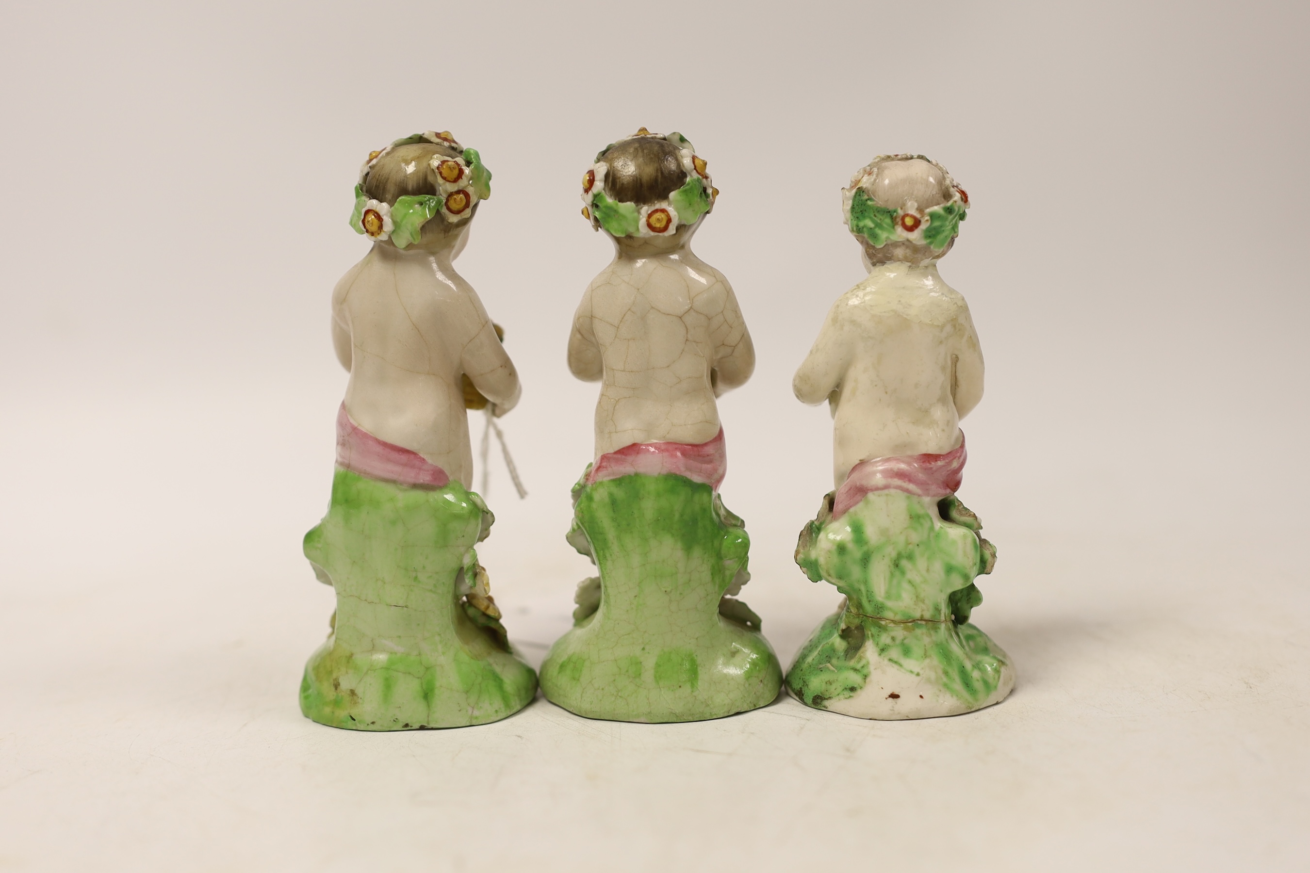 A group of three Chelsea style putti/nymphs, 11.5cm high